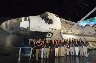 More than 40 NASA astronauts, including crew members from each of space shuttle Atlantis' 33 flights, give a thumbs up to the display of the retired orbiter following the exhibit's opening ceremony at the Kennedy Space Center Visitor Complex in Florida, June 29, 2013.