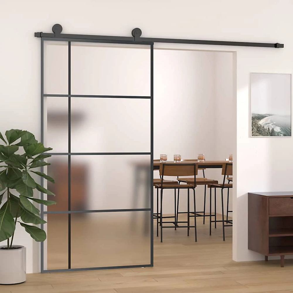 Black rim and frosted glass sliding doors mounted above an entryway to dining room