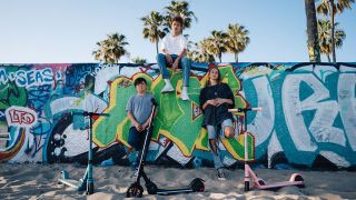 Three teens hang out on a beach with the SmooSat E9 Pro range.