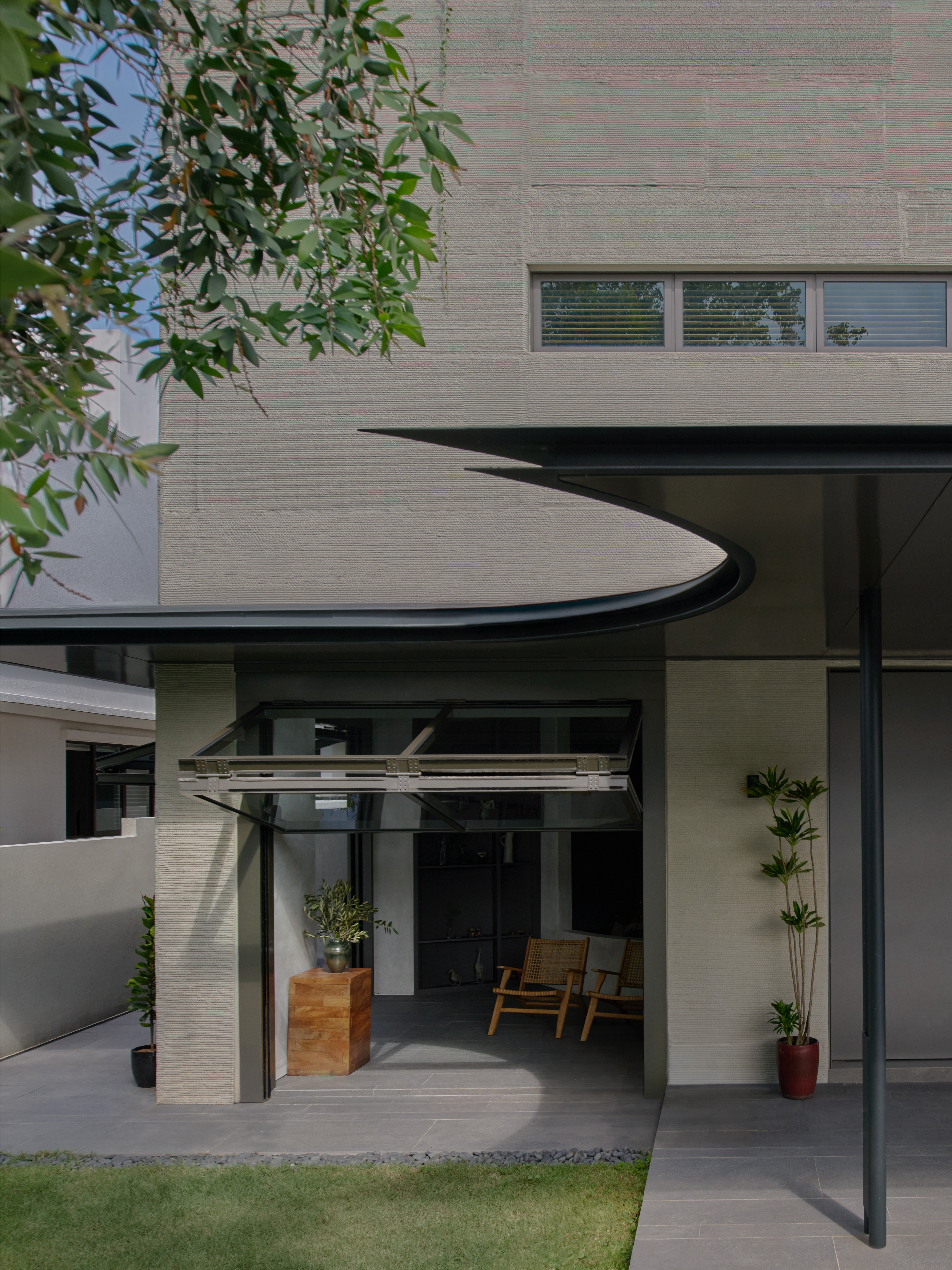 3d-printed concrete house with curved yellow wall in singapore