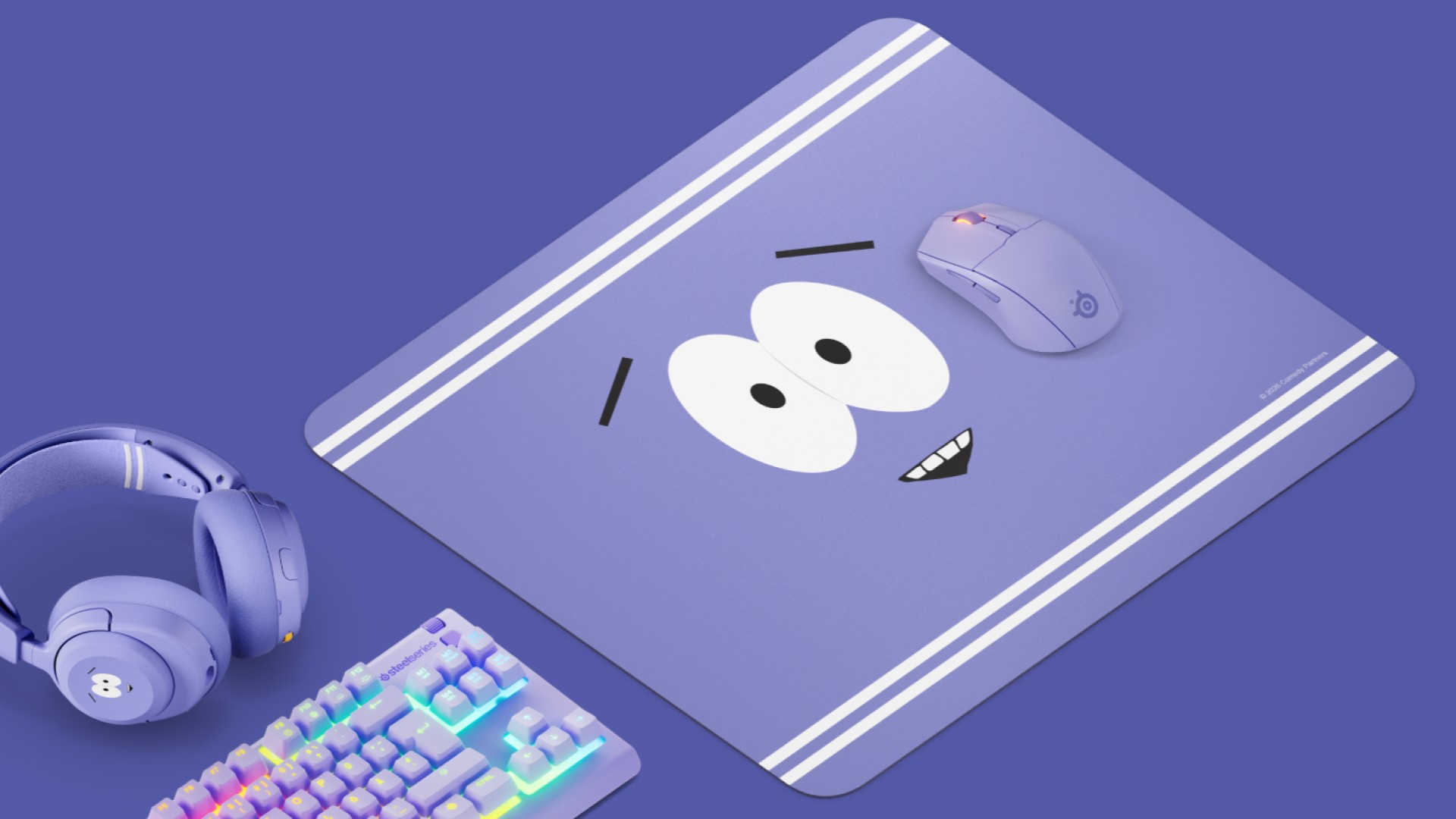 SteelSeries Towelie mouse pad with headset, mouse, and keyboard on a purple background