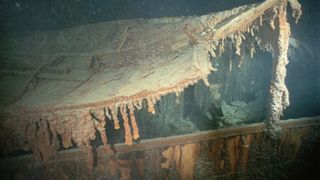 A section of the Boat Deck which has collapsed onto the Promenade Deck is hung with rusticles on the wreck of the Titanic. Rusticles are the work of bacteria acting on iron.