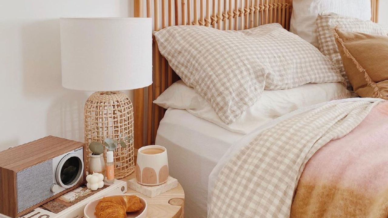 A brown and beige bed with a nightstand next to it