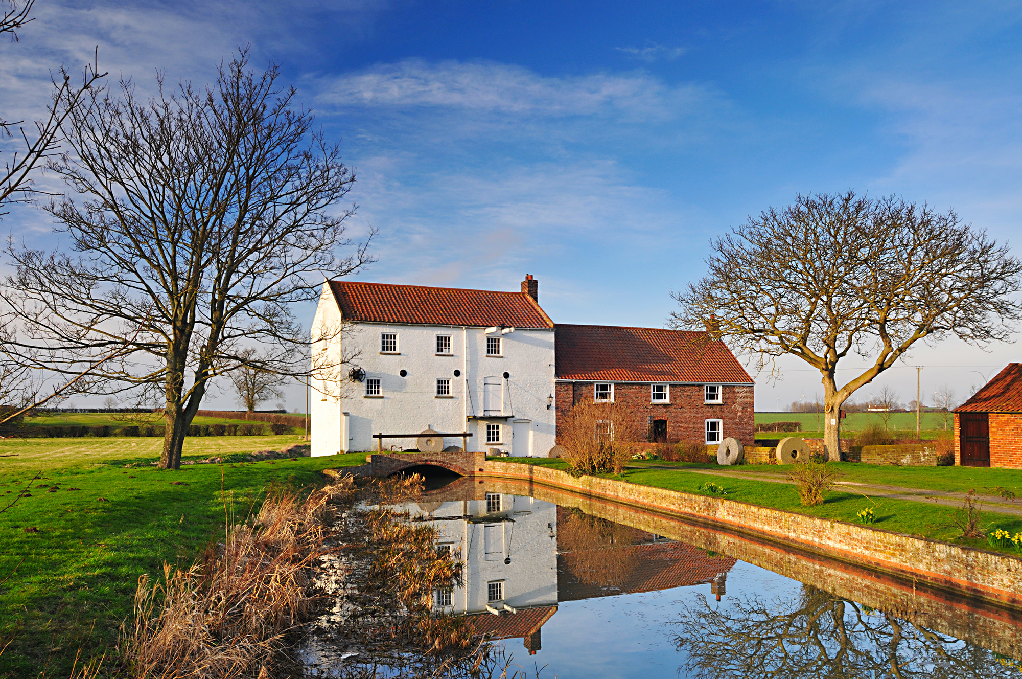 Watermill, pond, blue sky, trees