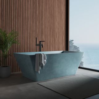 blue concrete bath tub in bathroom with wooden walls