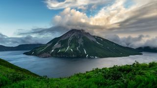 A photo of Krenitsyna Volcano and its crater lake taken from the crater's ridge