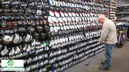 man looking at a golf club at golfclubs4cash shop