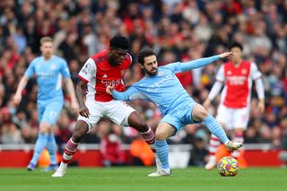 Thomas Partey of Arsenal challenges Bernardo Silva of Manchester City