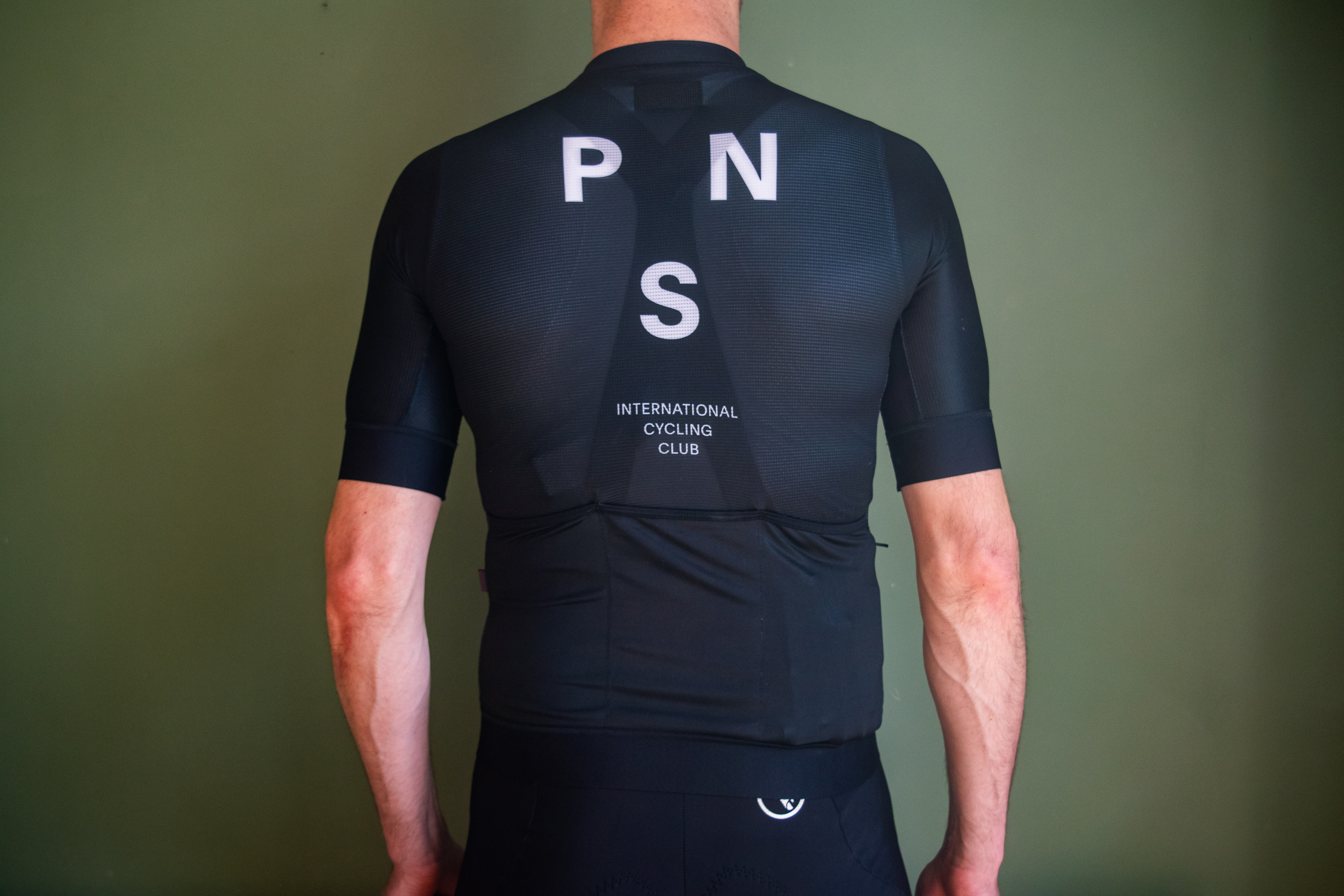 A man wearing a black PNS Mechanism jersey
