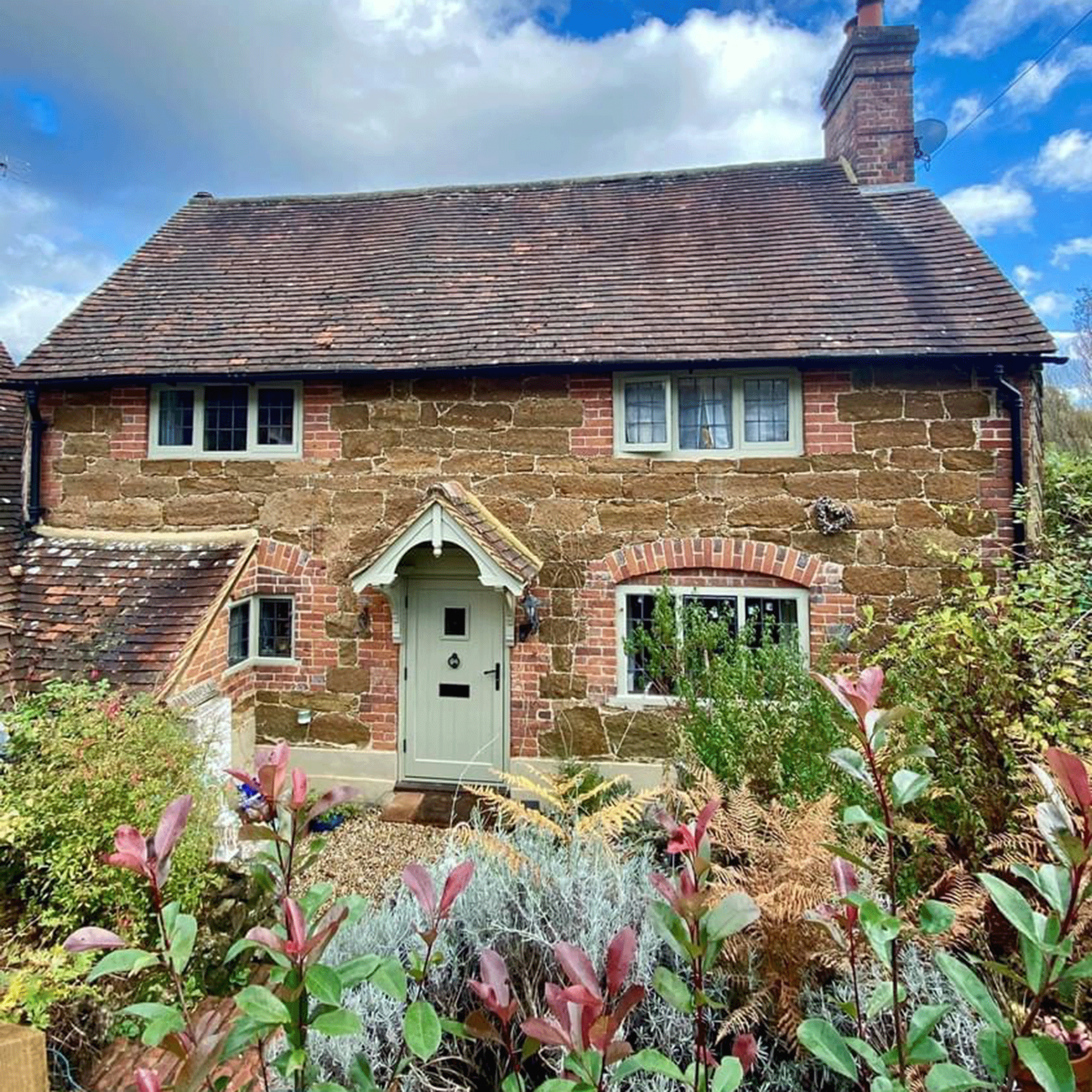 Holiday cottage exterior with green door