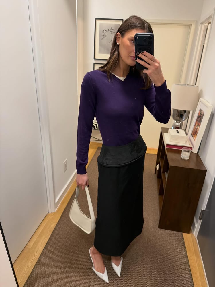 An image of @cocoschiffer wearing a purple V-neck jumper with a pencil skirt, two of the biggest fashion trends for spring 2026.