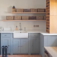 Light blue shaker kitchen with open shelving with baskets on top.