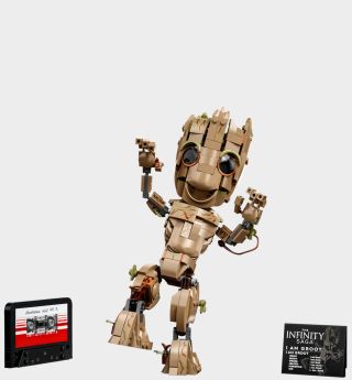 Lego I Am Groot set, cassette, and plaque on a plain background