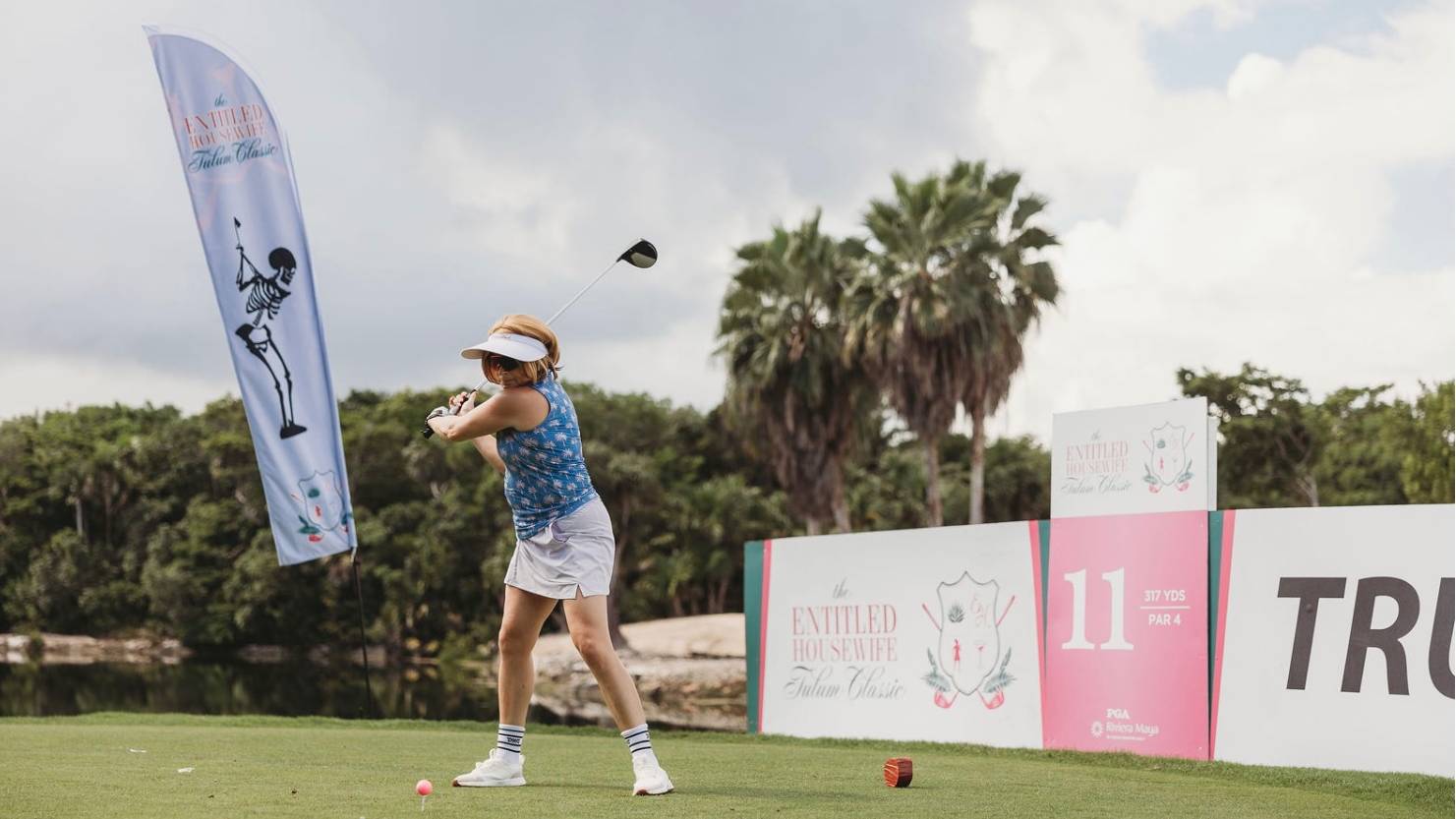 Becky Robinson hitting off the tee at the Entitled Housewife Tulum Classic