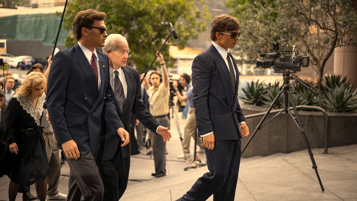 L-R: Erik (Cooper Koch), Peter Hoffman (Jeff Perry) and Lyle (Nicholas Chavez) arrive at court in &quot;Monsters: The Lyle and Erik Menendez Story&quot; on Netflix