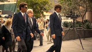 L-R: Erik (Cooper Koch), Peter Hoffman (Jeff Perry) and Lyle (Nicholas Chavez) arrive at court in "Monsters: The Lyle and Erik Menendez Story" on Netflix