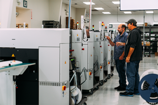 Employees inspecting manufacturing equipment