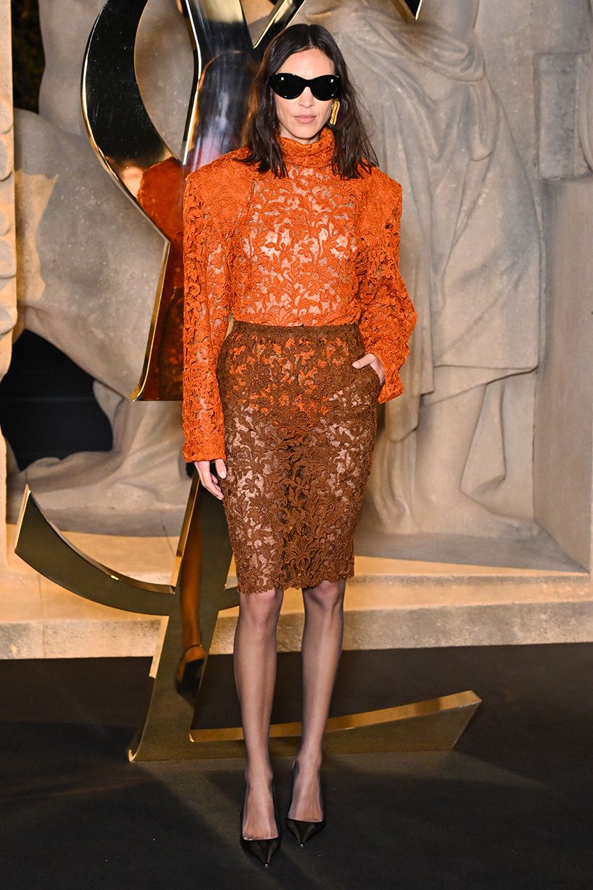 Alexa Chung wearing an orange lace top and brown lace skirt at PFW S/S 26