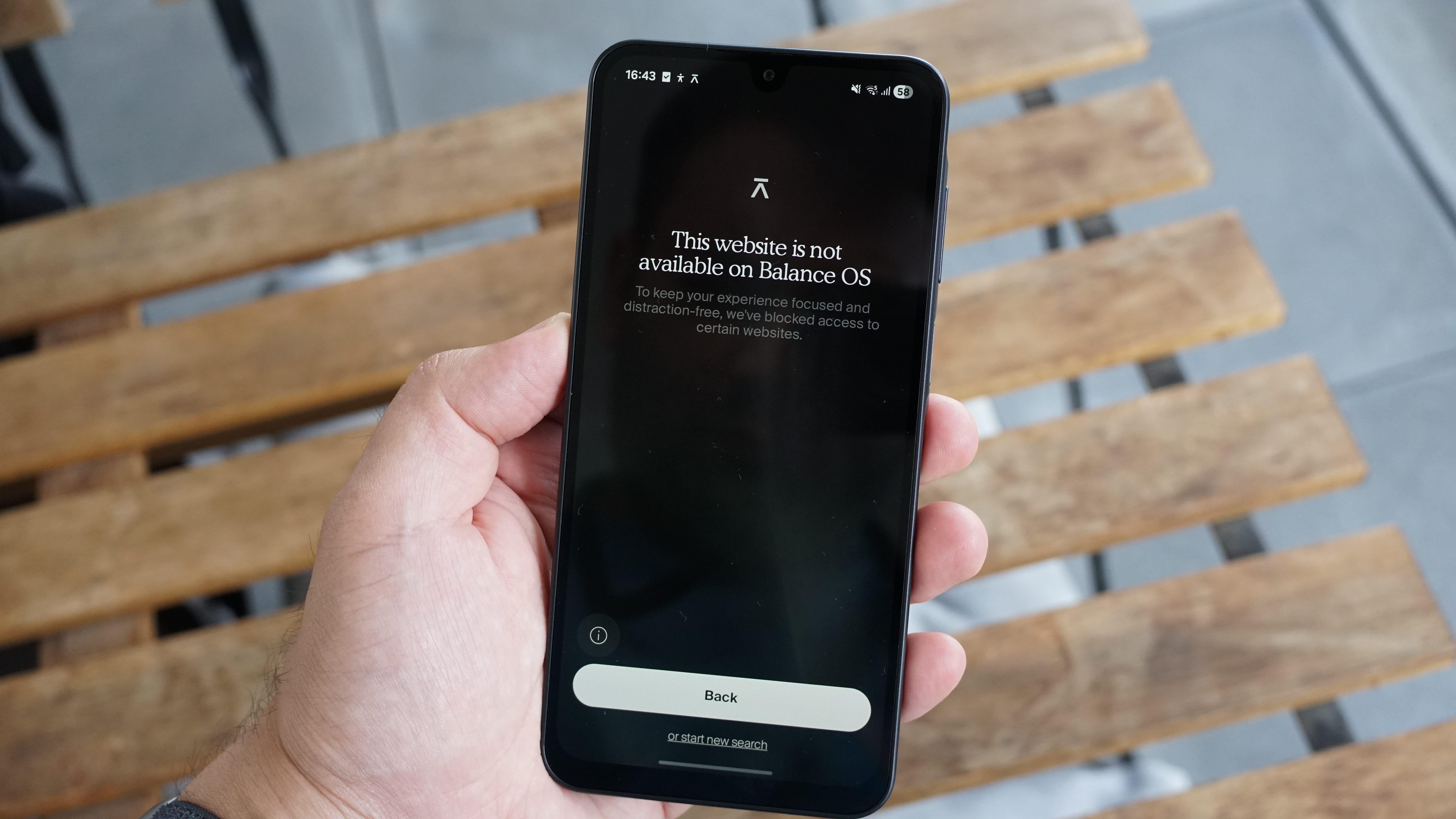 The Balance Phone being held in the hand
