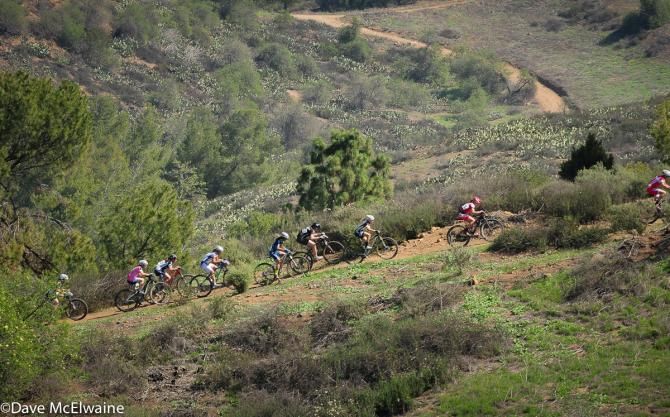 Riders on a steep climb at the end of lap one