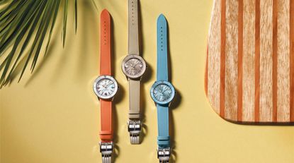 Three colourful Breitling watches on a yellow background, part of the SUPEROCEAN HERITAGE ’57 PASTEL PARADISE capsule collection