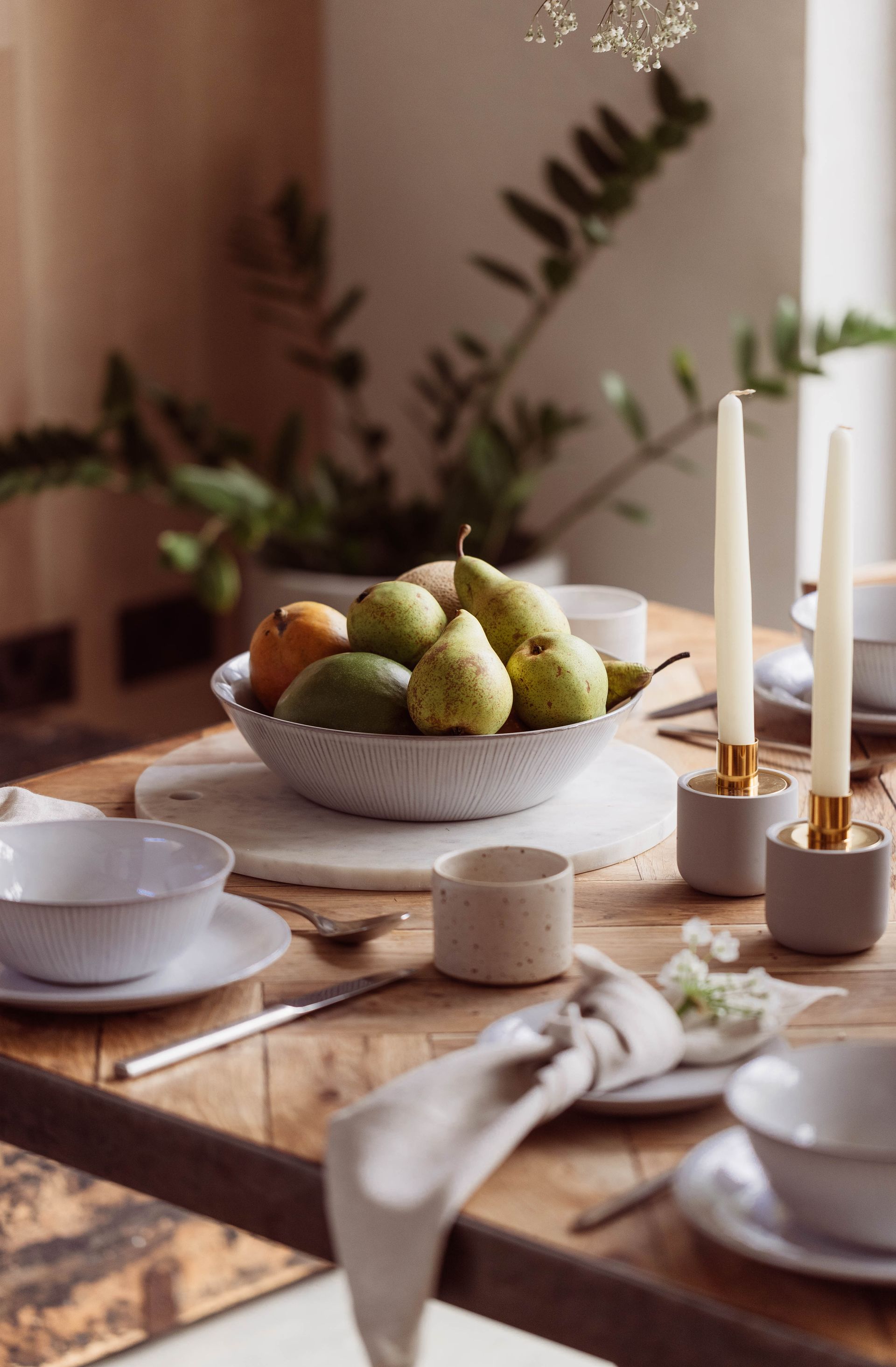 table set with fruit and candles