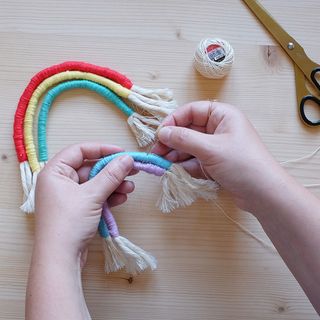 rainbow macrame bunting assembly with darning needle and scissors