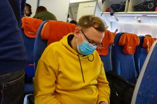 It may be a good idea to wear a face mask in a crowded place, such as an airplane, during the COVID-19 outbreak.