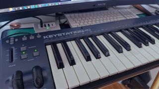 A MIDI keyboard on a studio desk