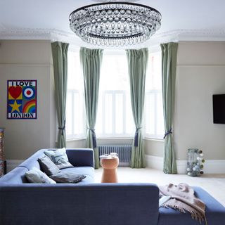 chandelier with curtains and sofa set with cushions