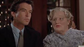 Pierce Brosnan and Robin Williams sitting at restaurant table in Mrs. Doubtfire