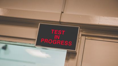 test in progress sign outside windtunnel