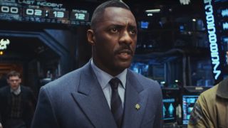 Idris Elba looks ahead in the control room while Burn Gorman approaches in Pacific Rim.
