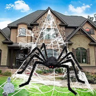 Best Halloween decorations: an image of the Bosoner 50" Giant Spider decoration in front of a house decorated for Halloween