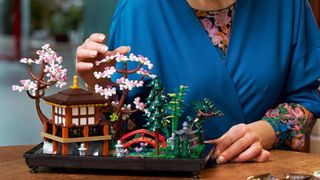 Hand interacting with Lego Icons Tranquil Garden set