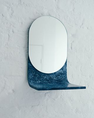 Mirror with integrated blue shelf