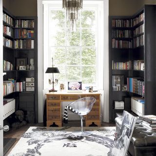 living room with book shelves and wooden desk