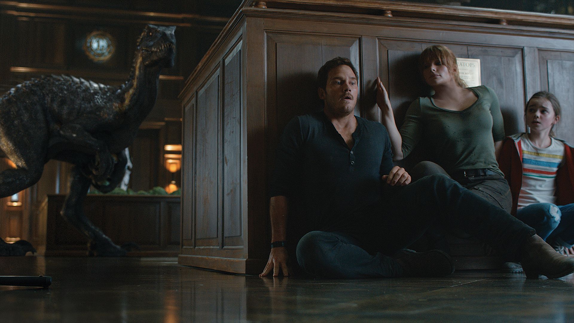 Owen Grady and company hide from a velociraptor on Jurassic World: Fallen Kingdom