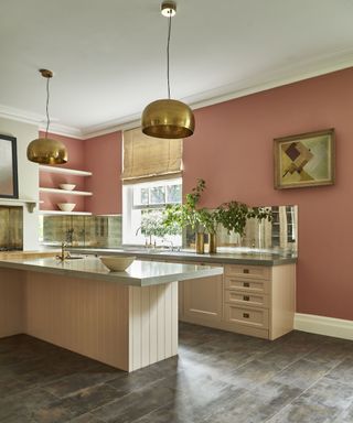 A modern kitchen with pastel pink peninsula, dark pink wall decor and luxury vinyl tile flooring