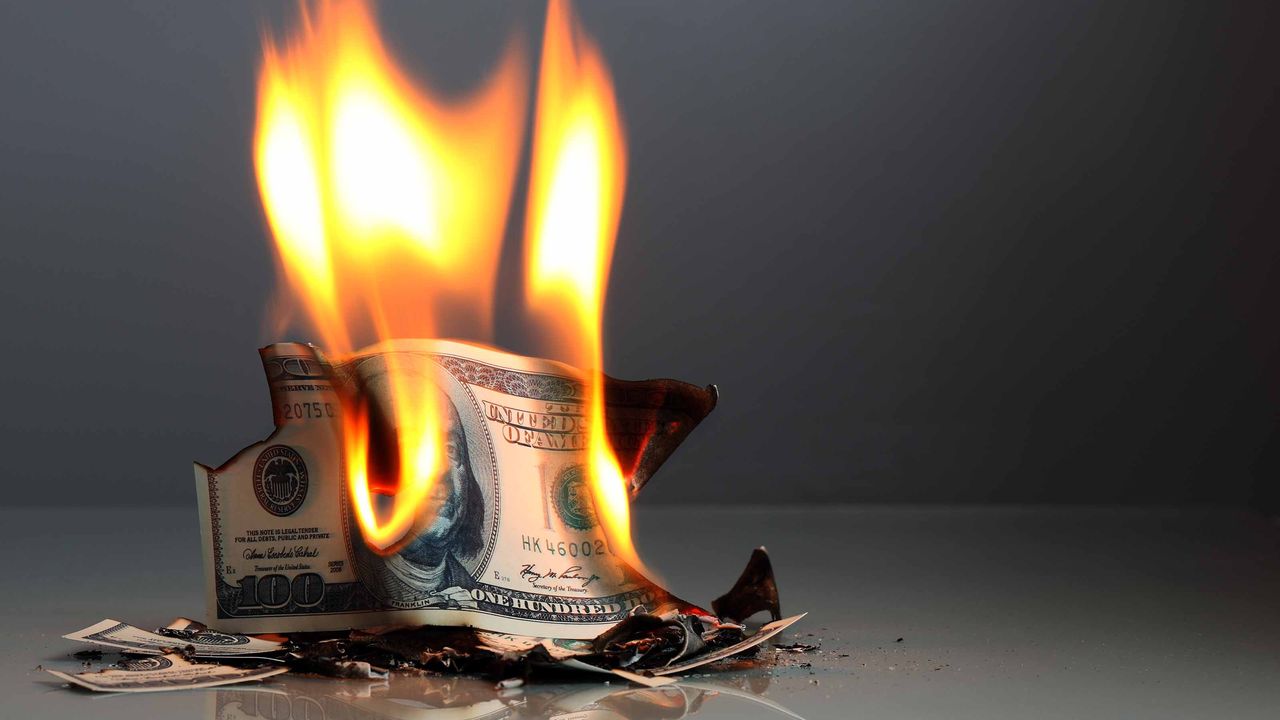 one-hundred dollar bill burning