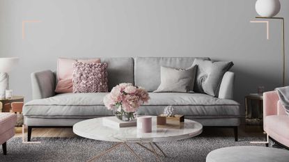 pale grey living room with grey upholstered sofa and brass metallic lamp and accessories to show the pleasing aesthetic when decorating with grey