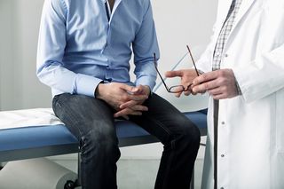 A man in consultation with a doctor.