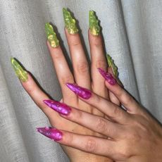 Charli XCX wearing jelly acrylic nails with water droplets.