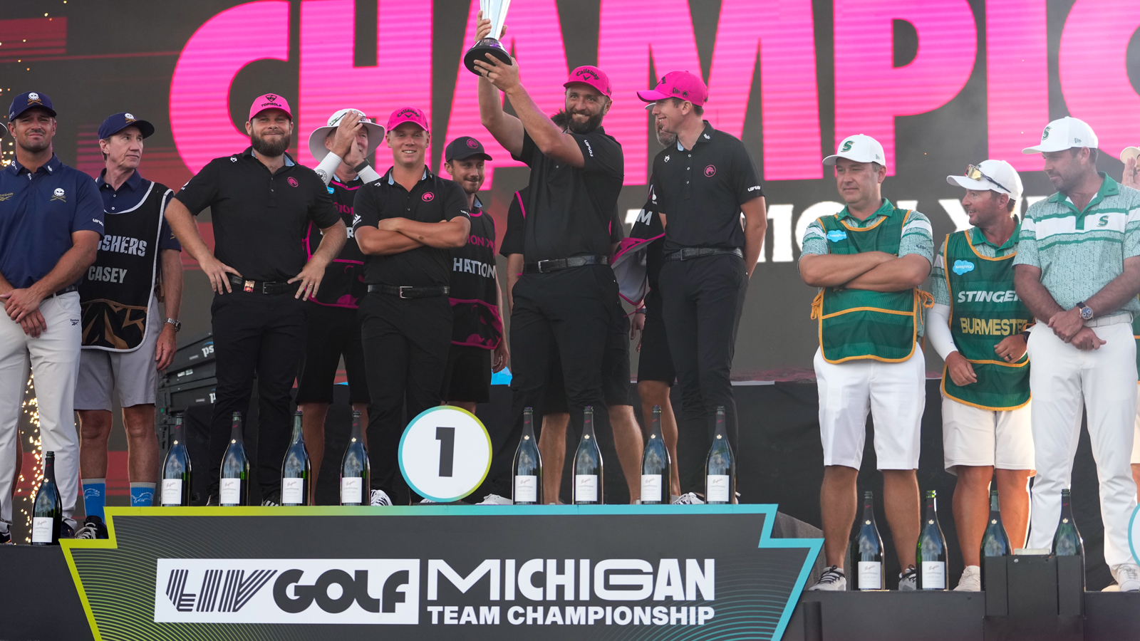 Jon Rahm lifts a trophy during LIV Golf's Team Championship