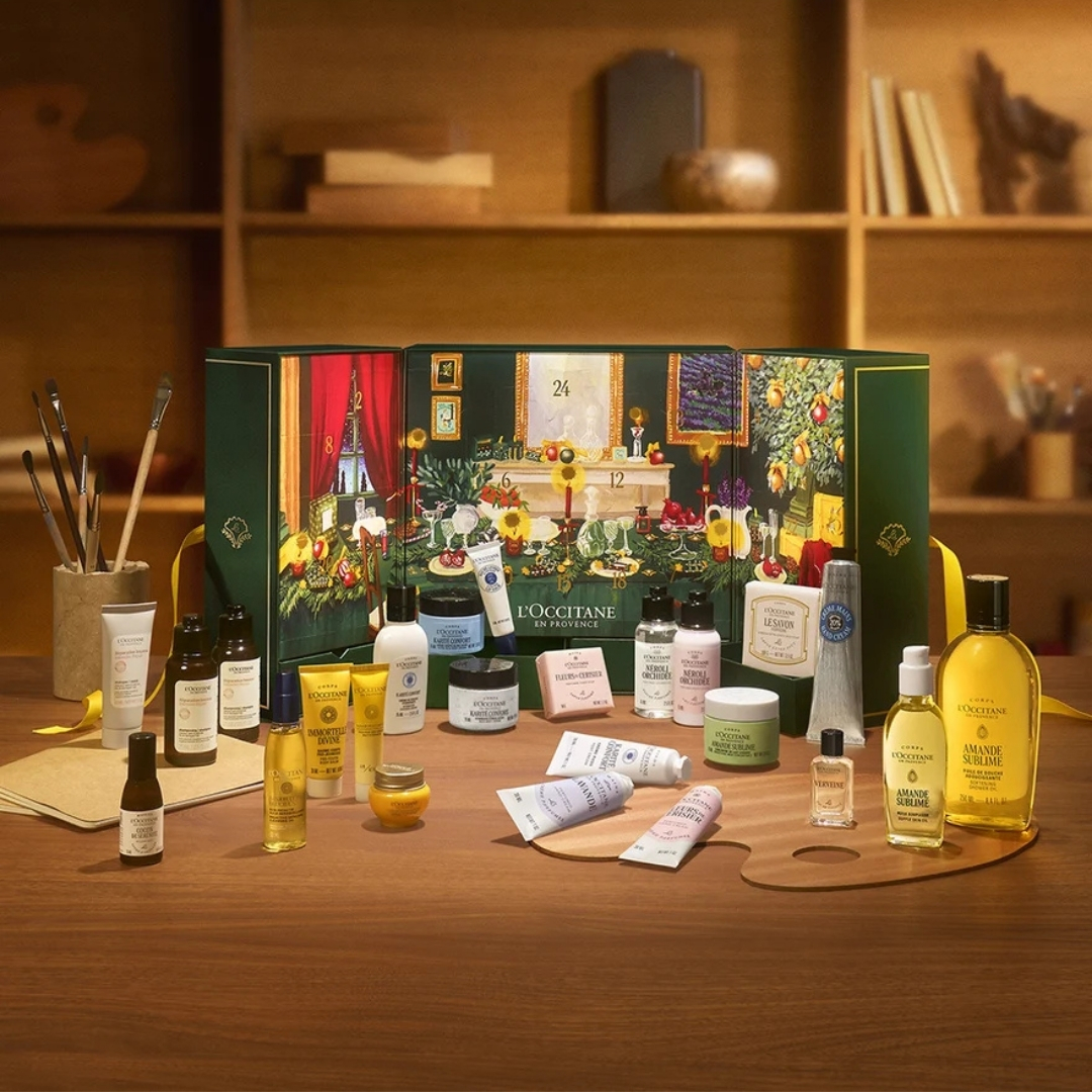L'Occitane Prestige Advent Calendar with its contents in front of it