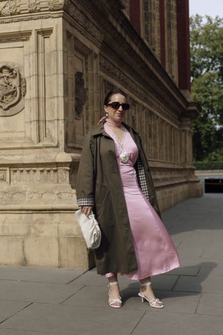 woman in trench coat and pink dress