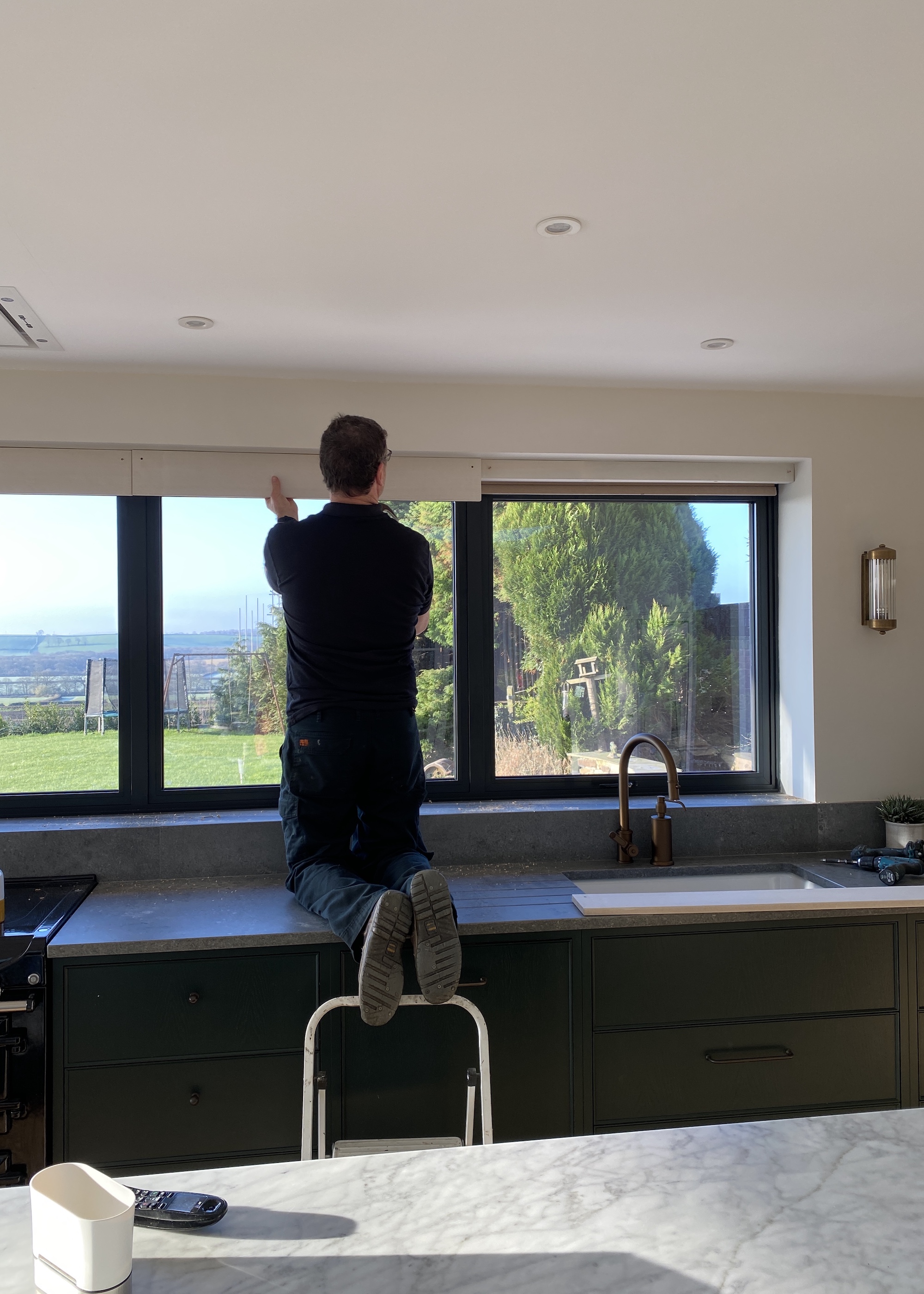 man fitting kitchen blind
