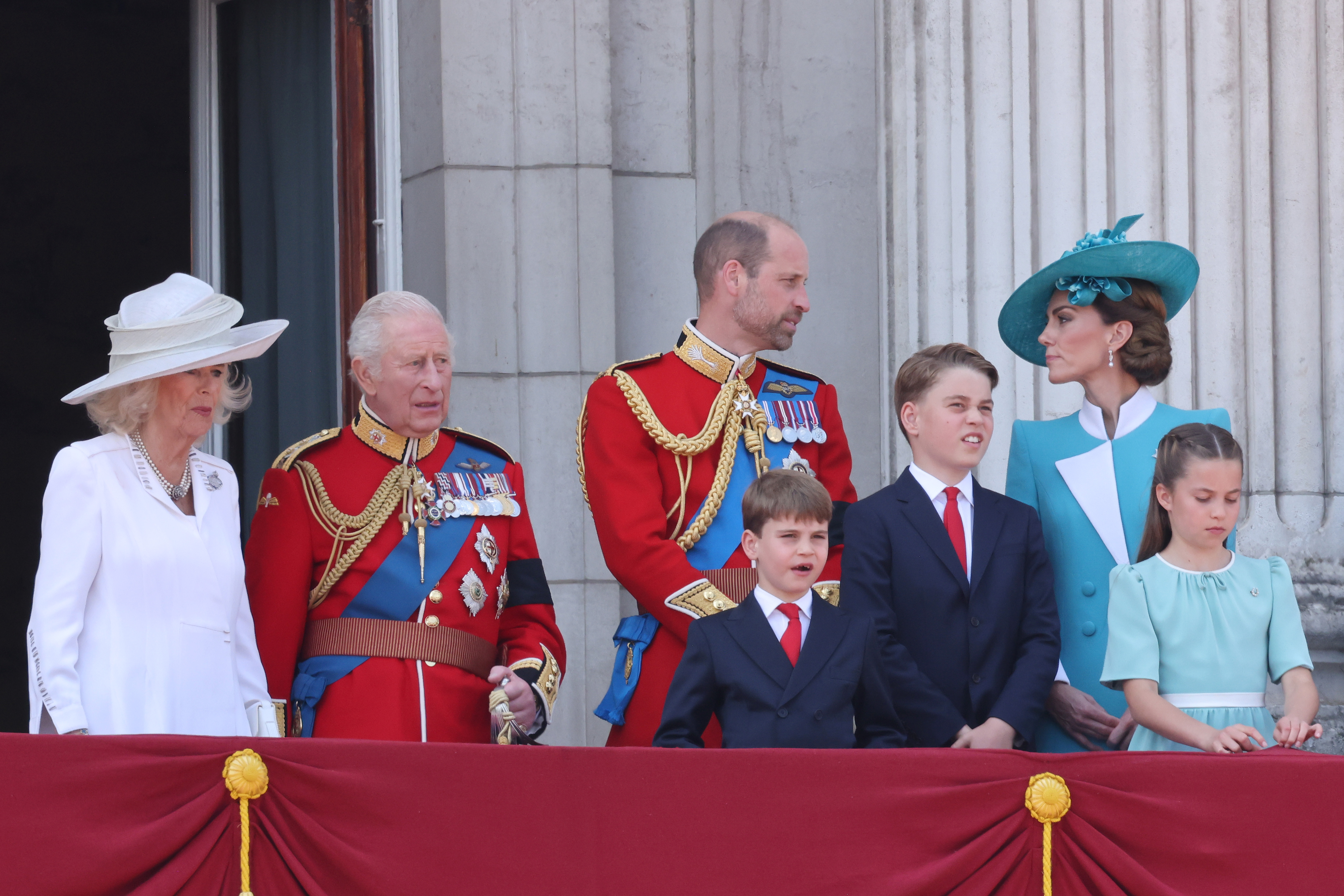 Kate Middleton and Prince William talking on the Buckingham Palace balcony at Trooping the Colour