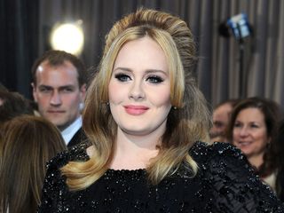 Adele in a black sequin dress with high volume hair