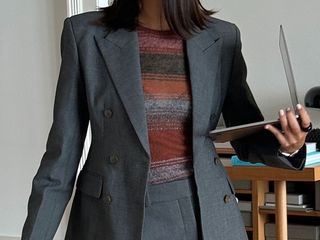 @salome.mory wearing a gray skirt suit.